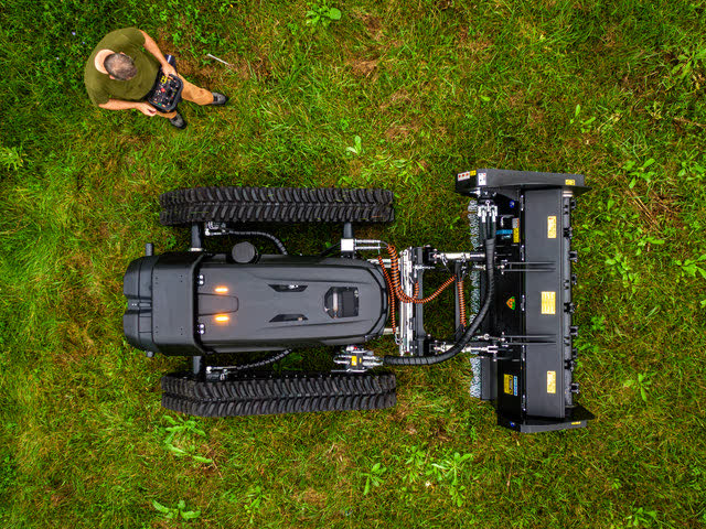 Overhead view of an operator working the machine from a distance with a handheld remote.
